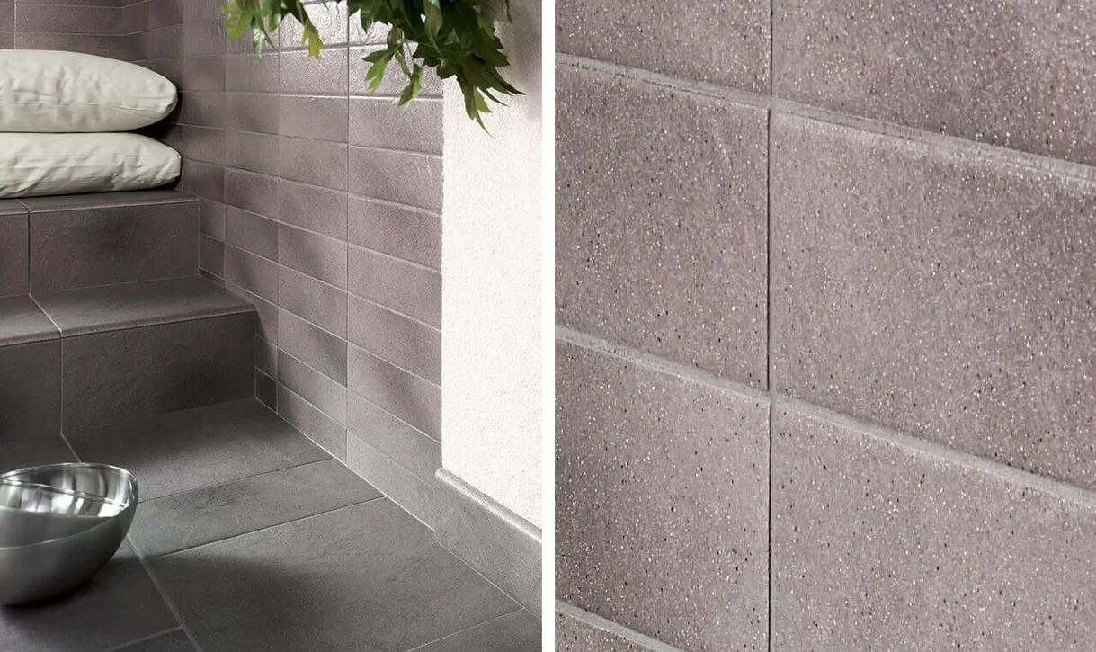 Minimalistyczny kąt z matowymi płytkami kamieniopodobnymi na podłodze i ścianach.
