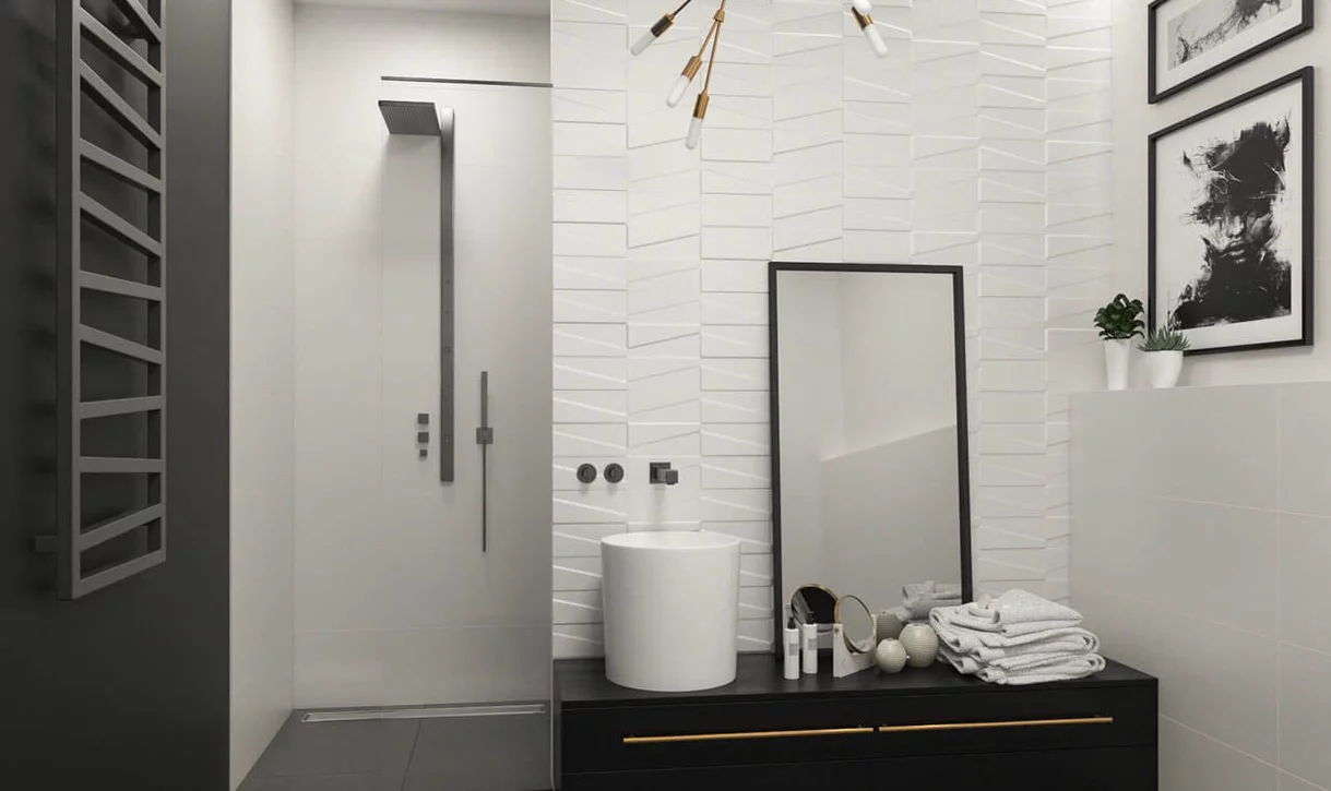 Nowoczesna łazienka z białymi ceramicznymi płytkami o geometrycznym wzorze i matowymi czarnymi armaturami.