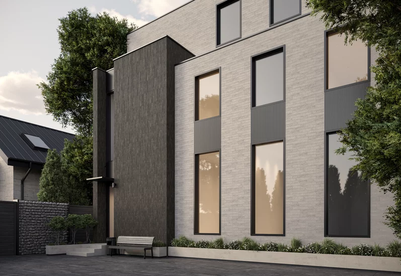 Elewacja nowoczesnego budynku z jasnoszarymi płytkami klinkierowymi inspirowanymi kamieniem z kolekcji Carrizo i ciemniejszymi płytkami betonopodobnymi.