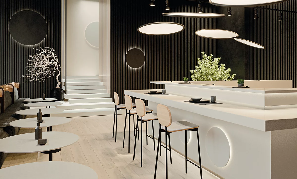 Nowoczesne wnętrze z dużymi płytkami zainspirowanymi kamieniem z kolekcji Imperial Tri-D i ciemnymi panelami ściennymi.