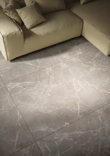 Elegant space with Proud Champagne tiles, contrast of light flooring and dark wall, and minimalist furniture.