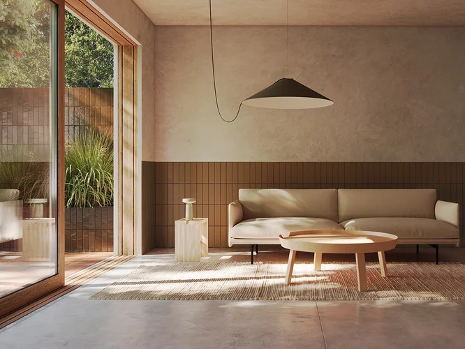 Minimalistyczny salon z brązowymi płytkami klinkierowymi z kolekcji Sundown na ścianie i płytkami imitującymi beton na podłodze.