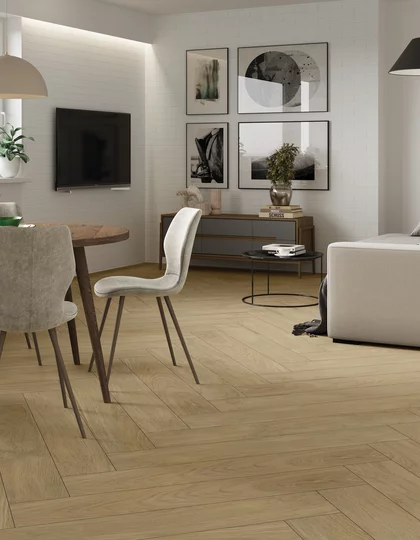 Salon i jadalnia z jasnymi płytkami drewnopodobnymi z kolekcji Warmwood i białą ścianą z prostokątnych płytek.